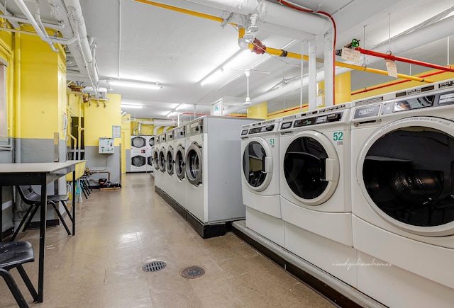 clothes washing area with washing machine and dryer