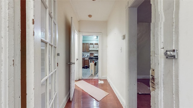 hallway with wood finished floors and baseboards