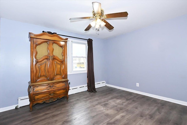 bedroom featuring ceiling fan, dark hardwood / wood-style flooring, and a baseboard heating unit