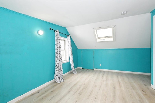 bonus room featuring lofted ceiling and light hardwood / wood-style floors