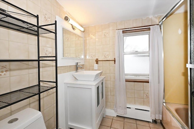 full bathroom with tile walls, shower / tub combo, vanity, tile patterned floors, and toilet