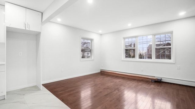 empty room with a baseboard radiator and light wood-type flooring