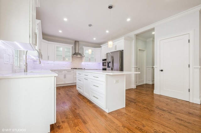 2101 Fir St, Wantagh, NY 11793 - kitchen with stainless steel fridge with ice dispenser, wall chimney range hood, backsplash, white cabinets, and crown molding