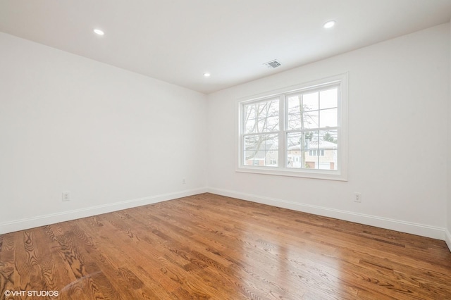 2101 Fir St, Wantagh, NY 11793 - spare room with wood finished floors and recessed lighting