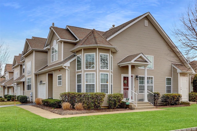 view of front of home with a garage and a front lawn