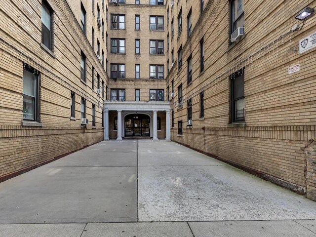 91 E 208th St Unit 3K, Bronx, NY 10467 - view of exterior entry with brick siding and cooling unit