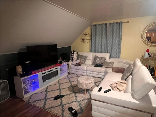 living room featuring vaulted ceiling and wood finished floors