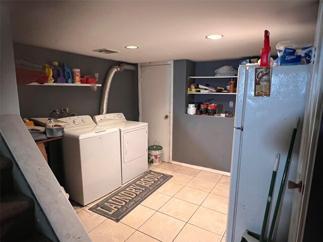 laundry area with recessed lighting, laundry area, light tile patterned flooring, and separate washer and dryer