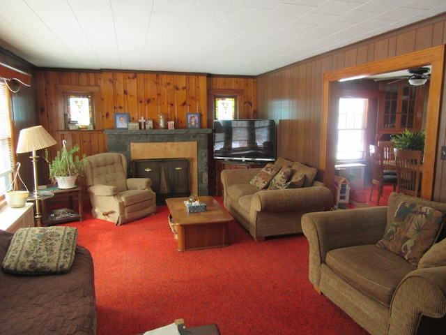 carpeted living room with wooden walls