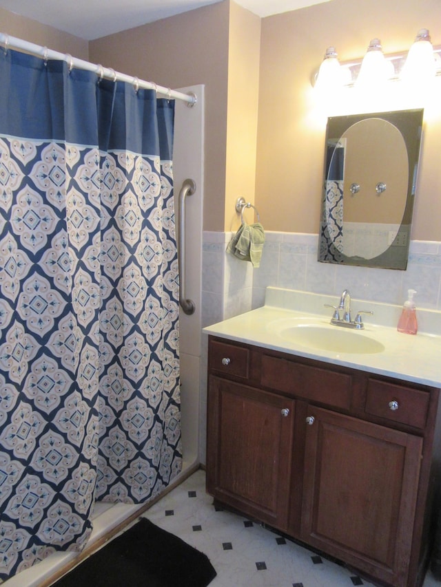 bathroom featuring vanity, tile walls, and a shower with shower curtain