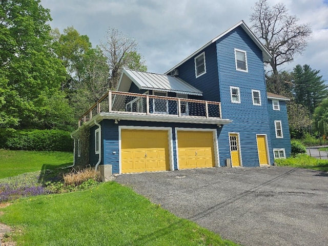 807 Lucas Avenue Ext, Hurley, NY 12443 - view of front facade with a balcony, a garage, driveway, and a front lawn