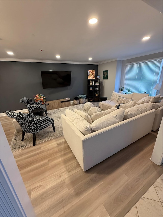 living room featuring light wood-style floors, crown molding, and recessed lighting