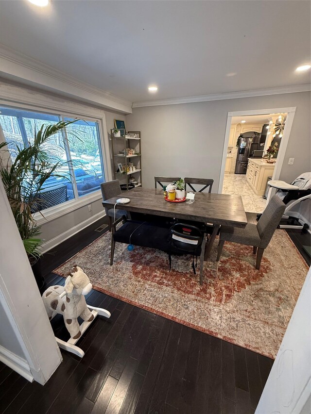 dining space with baseboards, ornamental molding, dark wood finished floors, and recessed lighting