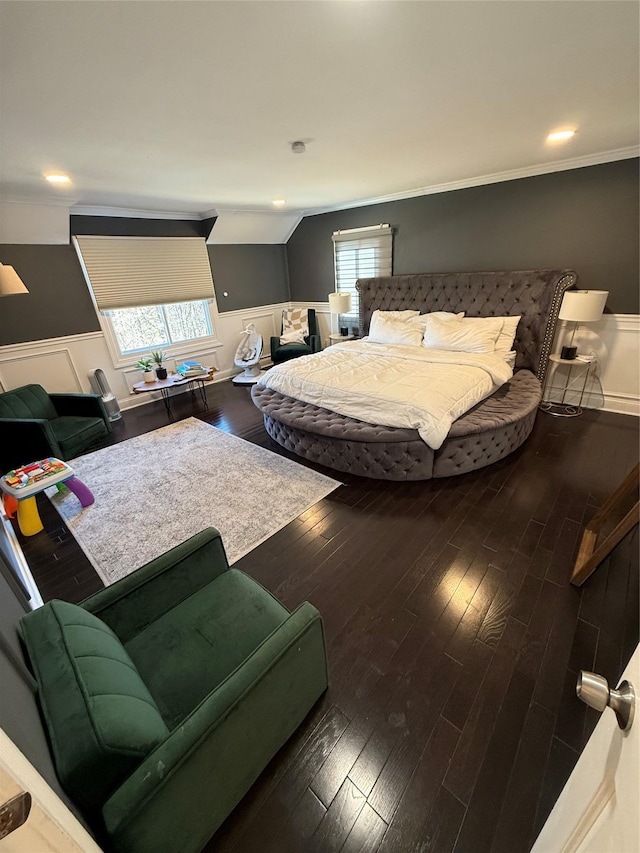 bedroom featuring lofted ceiling, dark wood-style flooring, wainscoting, and crown molding