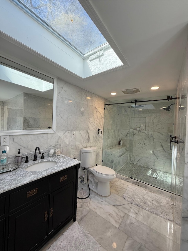 full bathroom with toilet, a skylight, vanity, visible vents, and marble finish floor