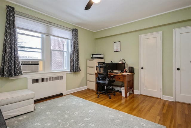 office space with radiator, hardwood / wood-style floors, and ceiling fan