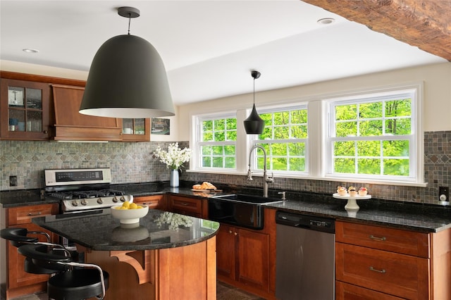 58 Spring Ln, Chappaqua, NY 10514 - kitchen featuring appliances with stainless steel finishes, a sink, tasteful backsplash, glass insert cabinets, and a kitchen island