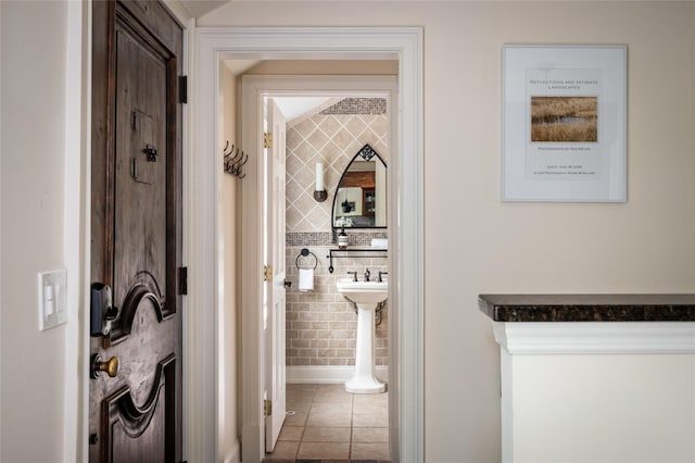 58 Spring Ln, Chappaqua, NY 10514 - corridor featuring tile patterned floors and tile walls