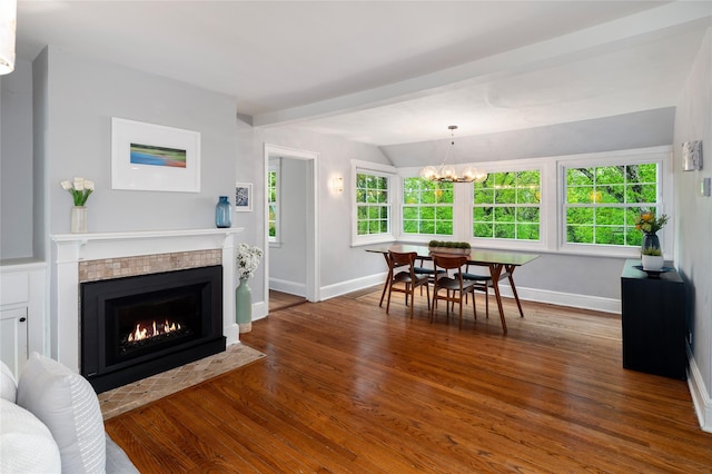 58 Spring Ln, Chappaqua, NY 10514 - dining area featuring baseboards, wood finished floors, a chandelier, and a tiled fireplace