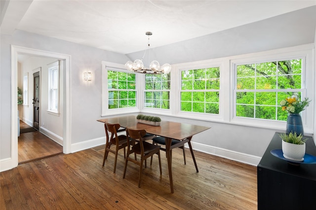 58 Spring Ln, Chappaqua, NY 10514 - dining room with baseboards, wood finished floors, a chandelier, and healthy amount of natural light