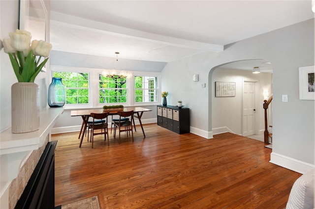 58 Spring Ln, Chappaqua, NY 10514 - dining space featuring arched walkways, plenty of natural light, wood finished floors, beam ceiling, and a chandelier