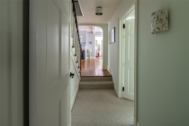 58 Spring Ln, Chappaqua, NY 10514 - corridor with arched walkways, light carpet, and baseboards