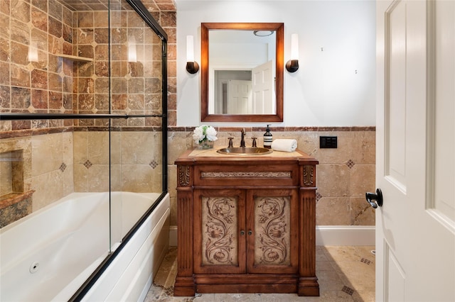 58 Spring Ln, Chappaqua, NY 10514 - full bath with tile walls, vanity, combined bath / shower with glass door, and a wainscoted wall