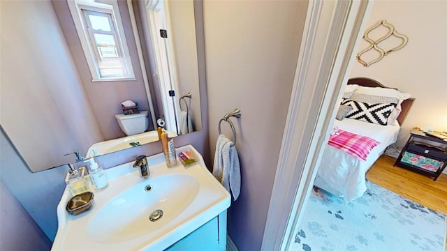 bathroom with vanity, hardwood / wood-style floors, and toilet