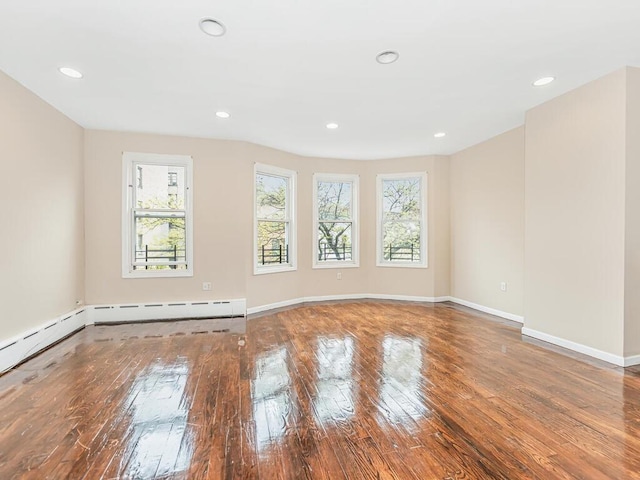 unfurnished room with hardwood / wood-style flooring and a healthy amount of sunlight