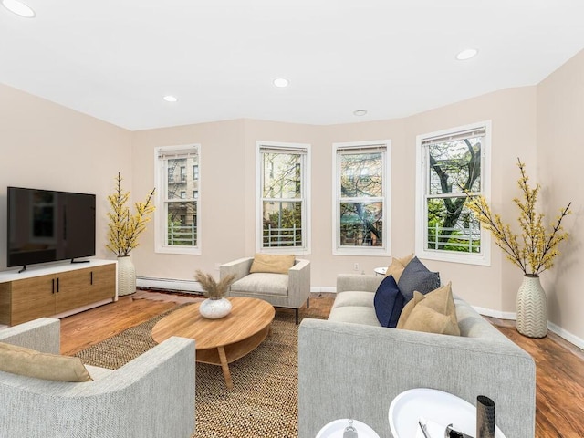 living room featuring hardwood / wood-style flooring and baseboard heating