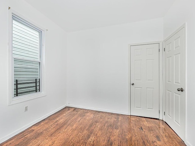 spare room with dark hardwood / wood-style floors