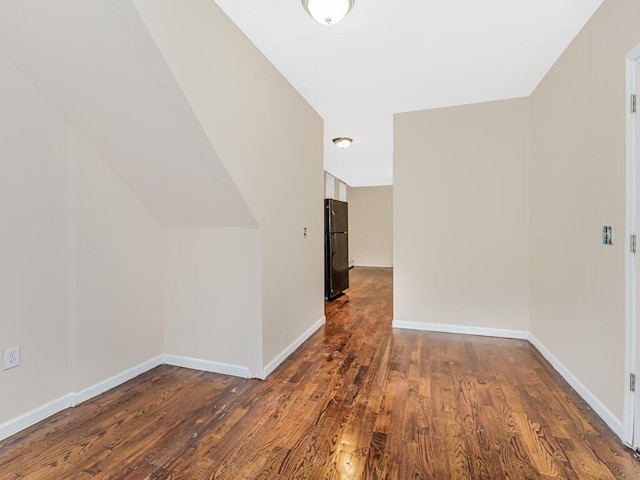 additional living space with lofted ceiling and dark hardwood / wood-style floors