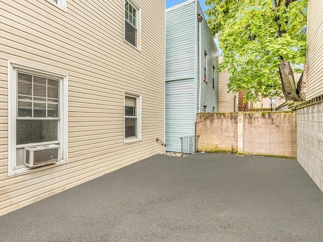 view of side of property with cooling unit and a patio area