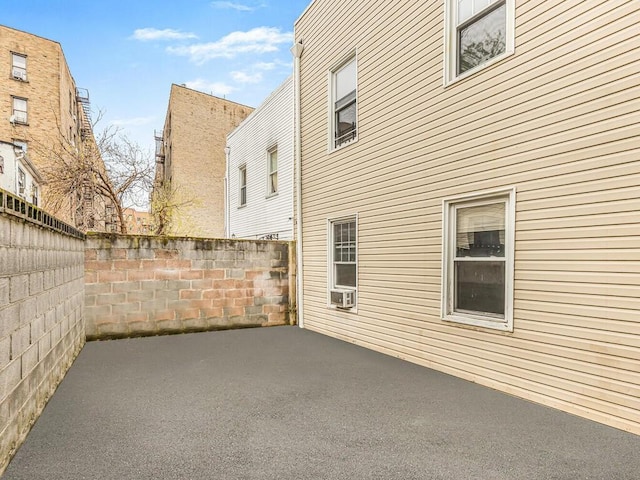 view of property exterior with cooling unit and a patio area