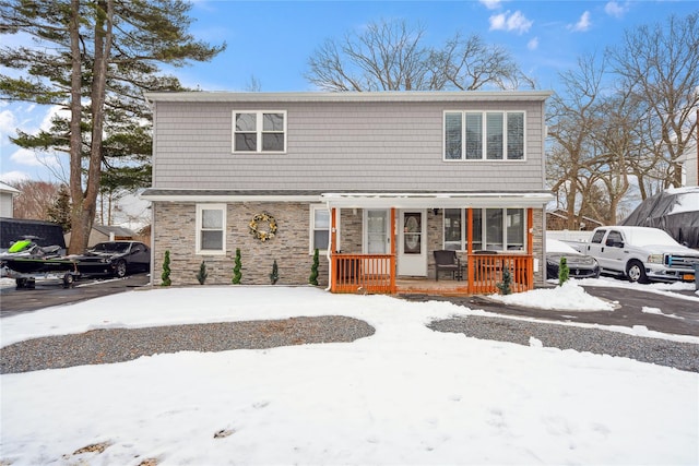 view of front of property with covered porch and stone siding