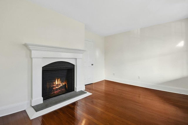 unfurnished living room featuring hardwood / wood-style flooring