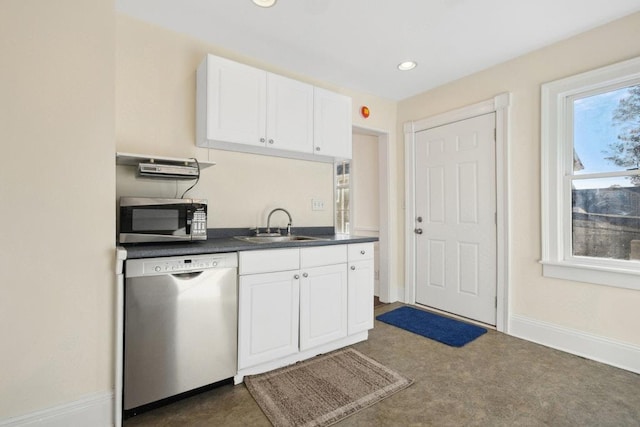 kitchen featuring stainless steel appliances, sink, and white cabinets