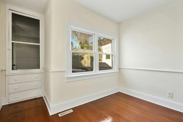 spare room featuring hardwood / wood-style flooring