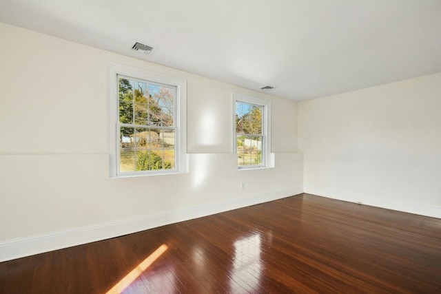 empty room with hardwood / wood-style floors