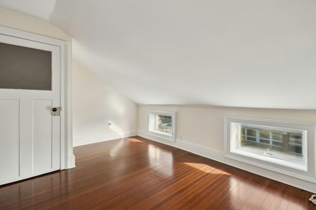 additional living space with lofted ceiling and dark wood-type flooring