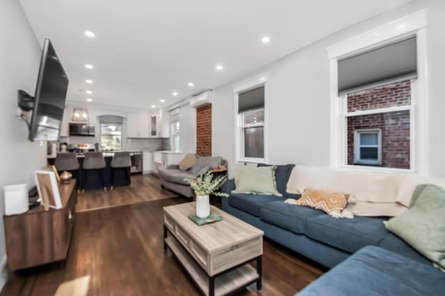 living room with dark hardwood / wood-style floors and a wall mounted AC