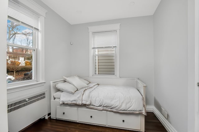 bedroom featuring dark wood-type flooring and radiator