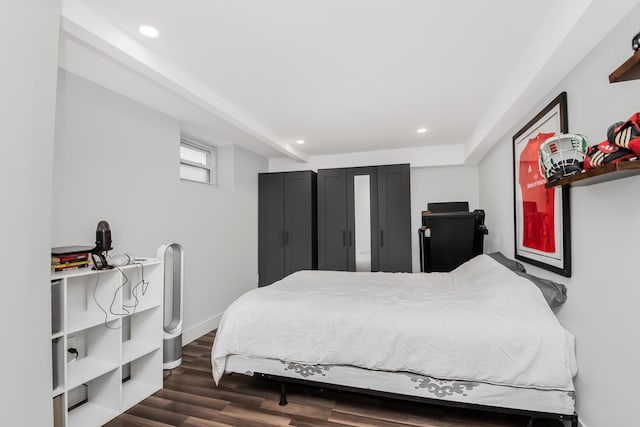 bedroom with dark hardwood / wood-style flooring