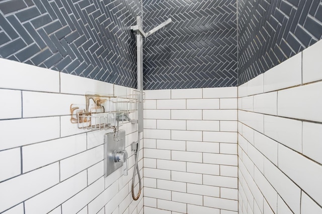 bathroom with tiled shower