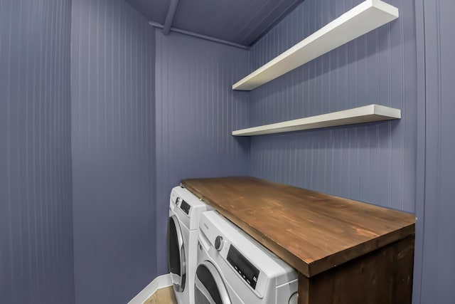 clothes washing area with washer and clothes dryer