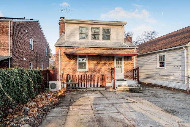 rear view of property featuring ac unit