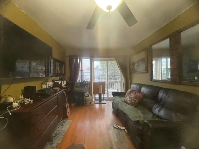 living room with ceiling fan and light wood-type flooring