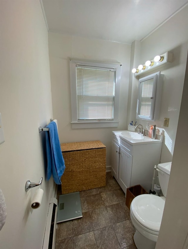 bathroom with vanity, a baseboard radiator, and toilet