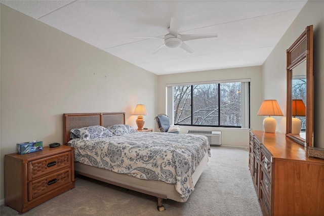 carpeted bedroom featuring ceiling fan and a wall mounted air conditioner