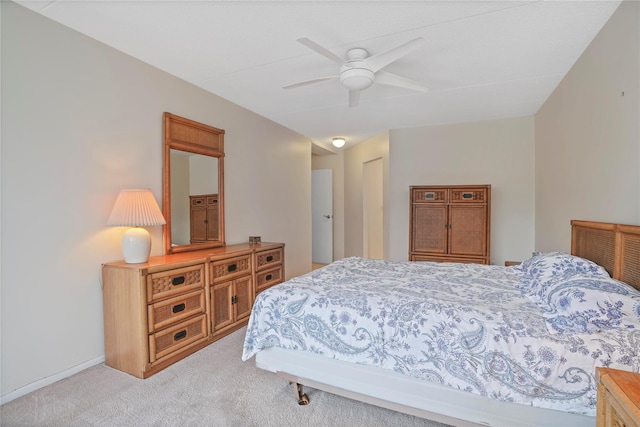 bedroom with light colored carpet and ceiling fan